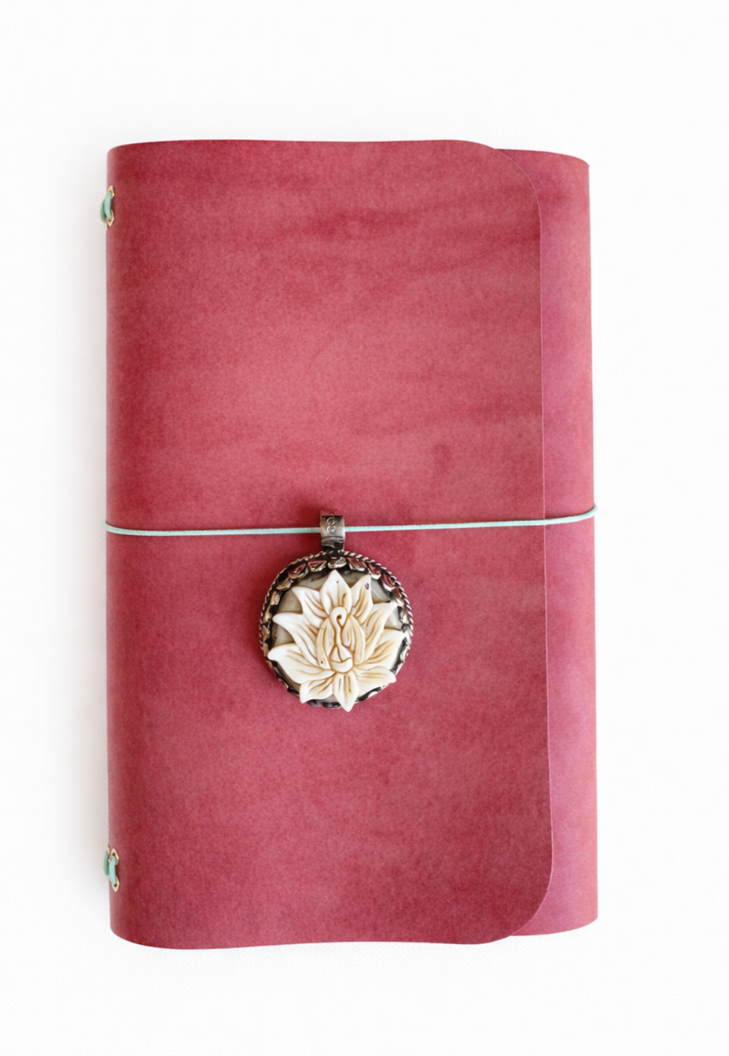 The Lotuskeeper Ritual A5 Journal - Coral pink veg tan matte leather journal with mint green cording, handcarved bone lotus front charm.
