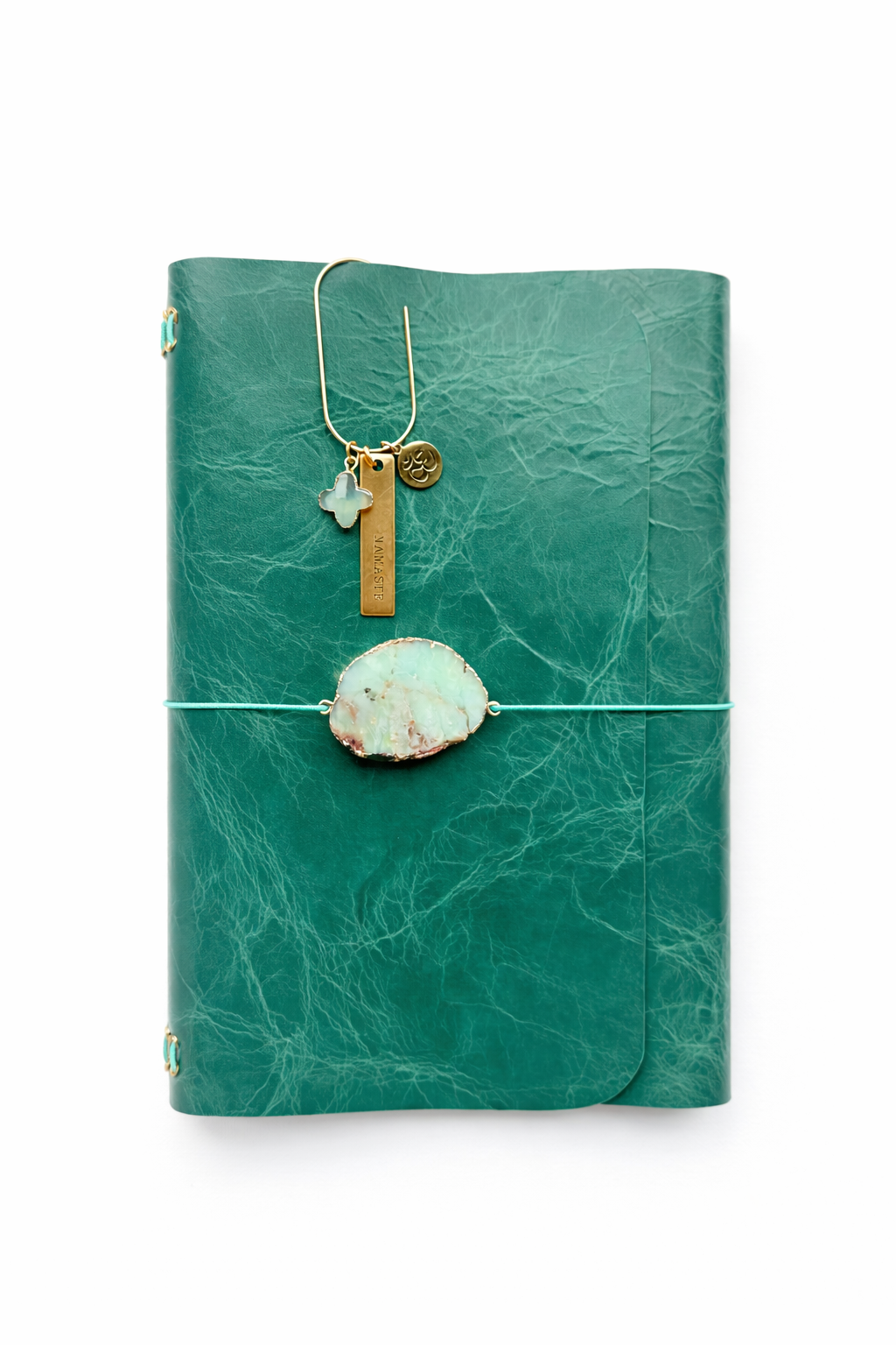 emerald chrome-tanned leather tri fold journal with a a large chrysoprase stone talisman. Featuring a bookmark with a trio of charms - clover, namaste, ohm symbol.