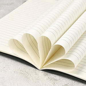 Open notebook with heart-shaped pages on a light gray background